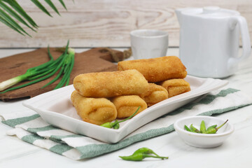 Risoles, one of Indonesian popular snack. Made from crepe skin filled with vegetables, chicken, coated with bread crumbs and deep fry. White marble background.   