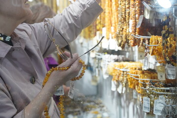 Visitors choose different amber jewelry.