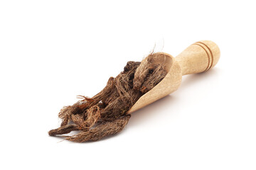 Front view of a wooden scoop filled with Organic Jatamansi (Nardostachys jatamansi) roots. Isolated...