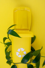 Yellow Trash Can Next to Green Plant