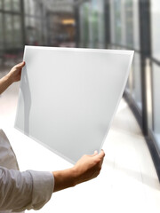 A Woman Holding an Empty Poster Mockup