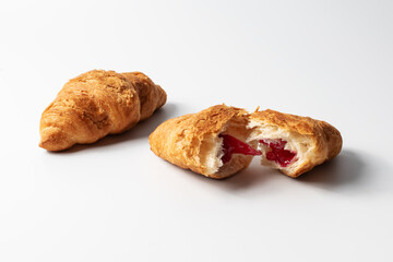 Delicious breakfast. Croissant with stuffing on a white background. French pastry