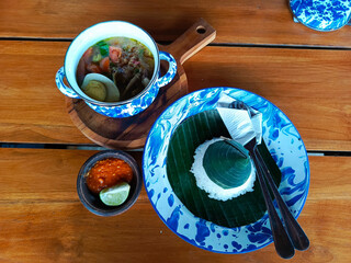 Soto Lamongan served in vintage tinware, evoking nostalgic village vibes, perfect for showcasing...