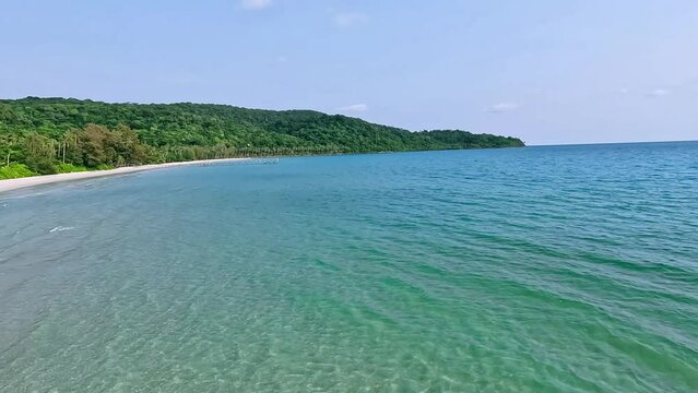 4K Drone Video: A sea in summer. Blue sea, white sand beach, very clear water. Looking at it makes you feel relaxed.