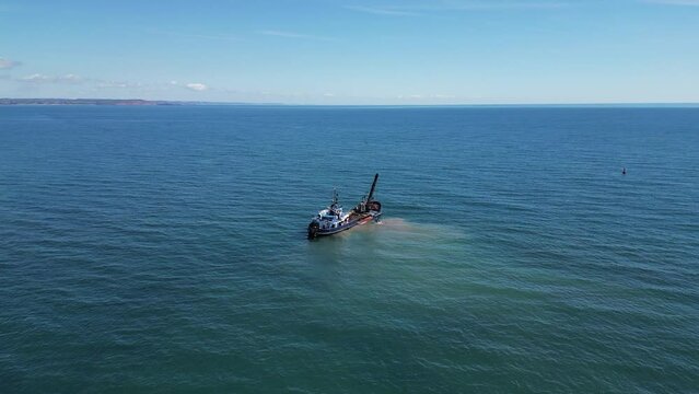 Teignmouth, South Devon, England: DRONE VIEWS: A dredger dredges sand and gravel close to the River Teign estuary; constant dredging ensures the unhindered passage of shipping to Teignmouth's&nbsp;port (3)