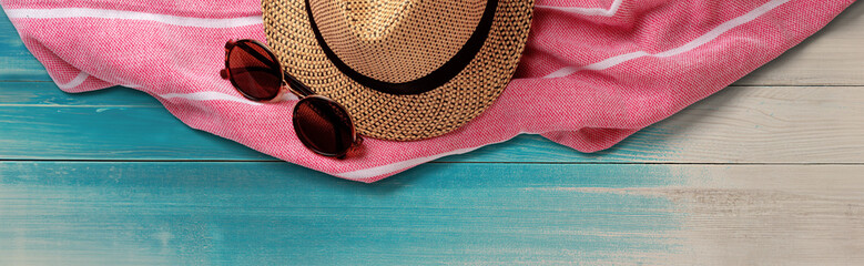 Summer Straw Hat, Towel and Sunglasses on Wooden Surface. File with Clipping Path.