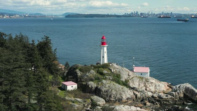 aerial view of point atkinson lighthouse in lighthouse park in West Vancouver with Vancouver city in the background, british columbia, canada