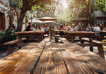 An outdoor cafe captures a trendy scene with people dining under the sun, while in the foreground, an empty wooden table suggests anticipation for gatherings