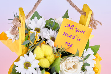 All you need is me. The phrase is written on the sticker on the flowers. Concept photo