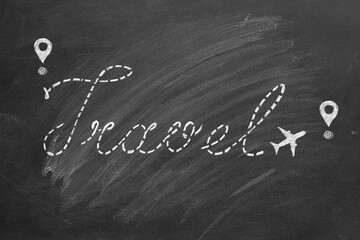 A chalk drawn airplane on the school blackboard writes the word travel. The concept of relaxation, travel, vacation, tourism.