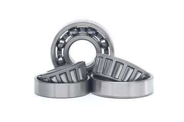 Tapered roller bearings and ball bearing isolated on white