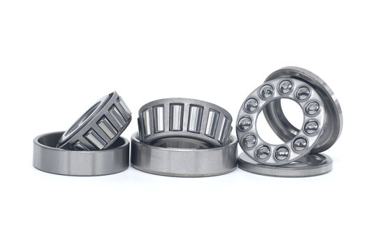 Tapered roller and thrust ball bearings isolated on white
