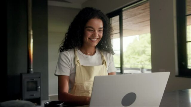 A woman is using a laptop computer at a table inside a building