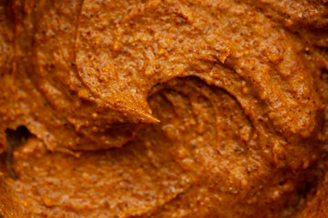 Baby food, vegetable puree close-up. Apple-carrot puree chopped in a blender. Background texture of...