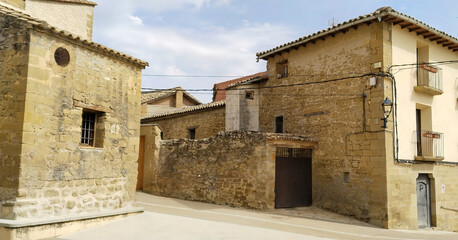 A small town with a stone building and a stone wall