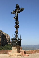 Cross with a crucifix in the Montserrat Mountain. Catalonia, Spain.