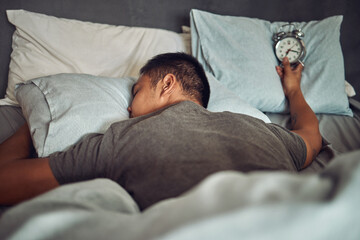 Man, sleeping and bed with alarm clock or tired insomnia for bad time management, depression or dreaming. Male person, pillow and lazy snooze in home or overworked burnout, mental health or Monday - obrazy, fototapety, plakaty