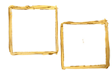 Two golden paint stroke frames on white, artistic for backgrounds and design.