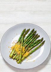 roasted asparagus with nut yeast crumble on plate