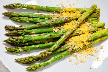 roasted asparagus with nut yeast crumble on plate