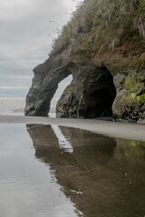 Arch rock formation at Three Sisters, Tongaporutu, Taranaki, New Zealand.