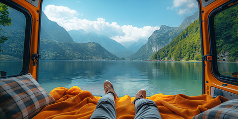 legs of a male traveler relaxation inside camper van in nature by a lake in mountain in summer - Powered by Adobe