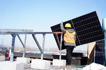 Workers install solar photovoltaic panels
