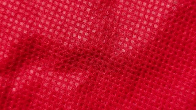 Abstract faded red color style fabric sheet surface background texture with copy space. Stop motion animation loop. Closeup macro top view.