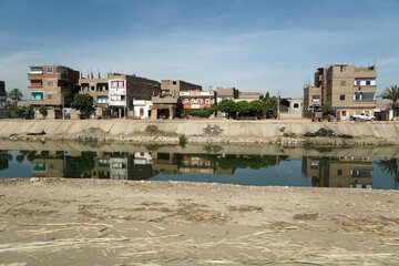 Houses on Nile irrigation canal shore. Egypt.