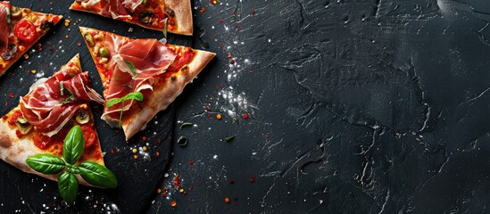 Pizza slices topped with prosciutto and seasonings on a black background, with space for writing, seen from above.