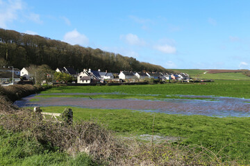A view across flooded fields in the pretty village of Dale, Pembrokeshire, Wales, UK.