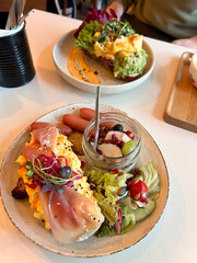 Breakfast Restaurant served Scrambled Eggs with Proscuitto on Toast Bread and Avocado Mash Guacamole.