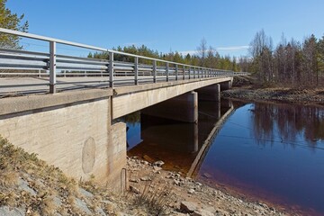 Concrete bridge over Heikkisenniva river in spring, Kuusamo, Finland.