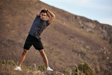 Athlete, man and fitness on mountain by stretching in portrait for exercise, training and workout for health. Active and male person in Mexico on path for muscles, wellness and calm in nature