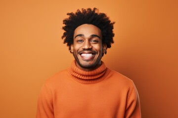 Fototapeta na wymiar Portrait of a satisfied afro-american man in his 20s wearing a cozy sweater in solid color backdrop
