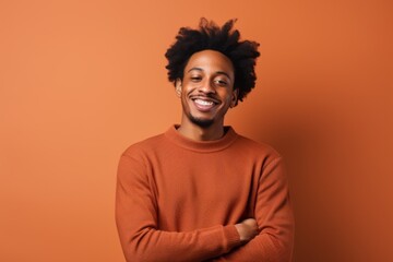 Fototapeta na wymiar Portrait of a satisfied afro-american man in his 20s wearing a cozy sweater on solid color backdrop