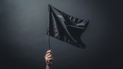 Creative angle of a hand holding a flag, fluttering with a sense of motion, against a starkly isolated background, high contrast studio lighting - obrazy, fototapety, plakaty
