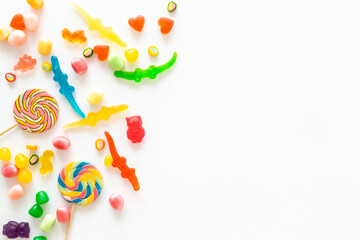 Colorful lollipops and different gummies jelly and candies, top view