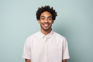 Portrait of a satisfied afro-american man in his 20s wearing a simple cotton shirt isolated in...