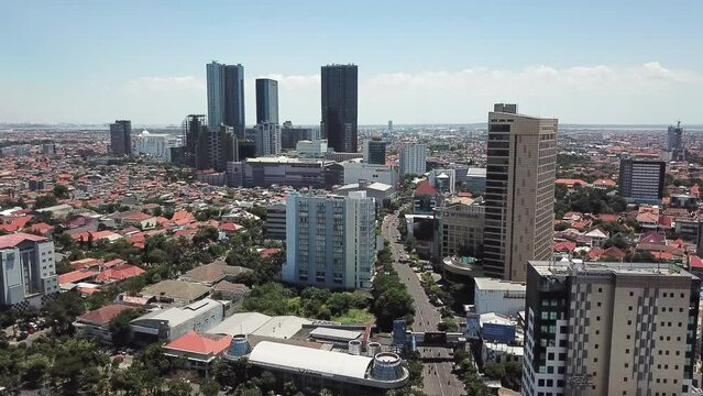 Surabaya, Indonesia - September 18, 2021:  Drone shot aerial view of Basuki Rahmat road. Skyline of Surabaya Center. 