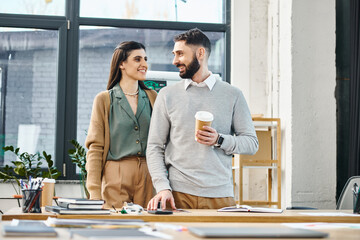 A man and a woman engage in productive discussion in a modern office space, highlighting corporate...
