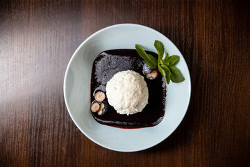 white ice cream with chocolate souce in white dish