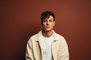 Fototapeta premium Portrait of a glad man in his 20s wearing a trendy sunglasses isolated in plain cyclorama studio wall