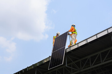 Worker installs solar panels. Worker installs solar panels at a solar farm field.
