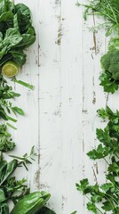 Fototapeta premium Assortment of fresh green vegetables and herbs on a white wooden background.