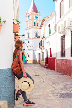 female tourist visiting typical white village in Andalusia, Spain- Ronda, Arriate