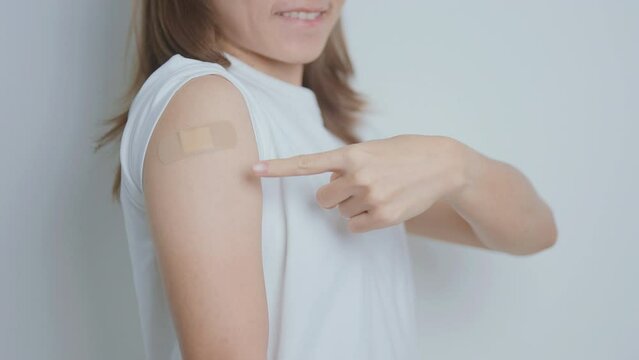Woman with bandage after receiving vaccine. Vaccination and Immunization for Influenza, HPV, Zoster, IPD, DTP or Diphtheria, Tetanus and Pertussis, MMR, Hepatitis B, Covid  and Varicella vaccine