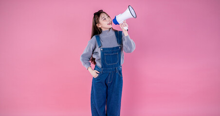 Portrait of young fun smart happy asian girl isolated on pink background studio shot. Happy model asian woman hold megaphone loud speaker big sale Black Friday, business market promotion concept