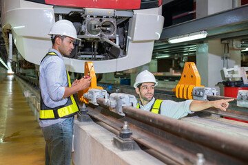 Engineers check the readiness of electric train tracks at the maintenance factory.