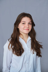 A high school student in uniform on a gray background.